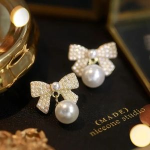 Bowknot faux pearl stud earrings